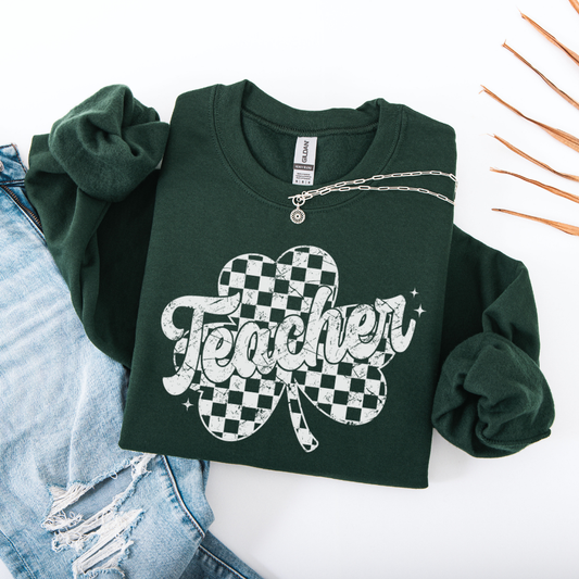Green sweatshirt with 'Teacher' and shamrock design on a white background
